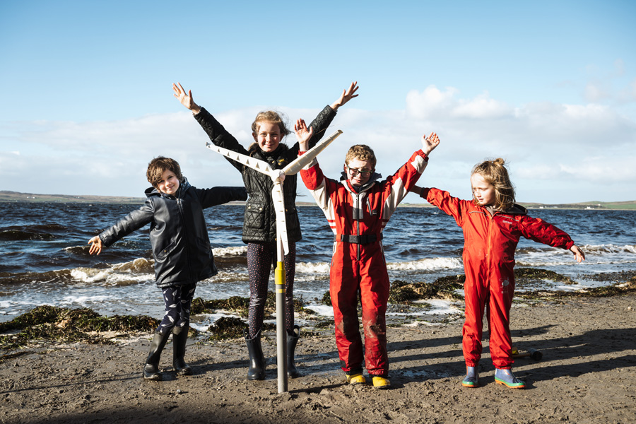 Children pose with a mock windmill